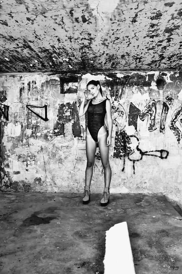 photographer SwimsuitProject swimwear modelling photo. simona wearing a stripy onepiece swimsuit and boots in an old fortress on malta .
