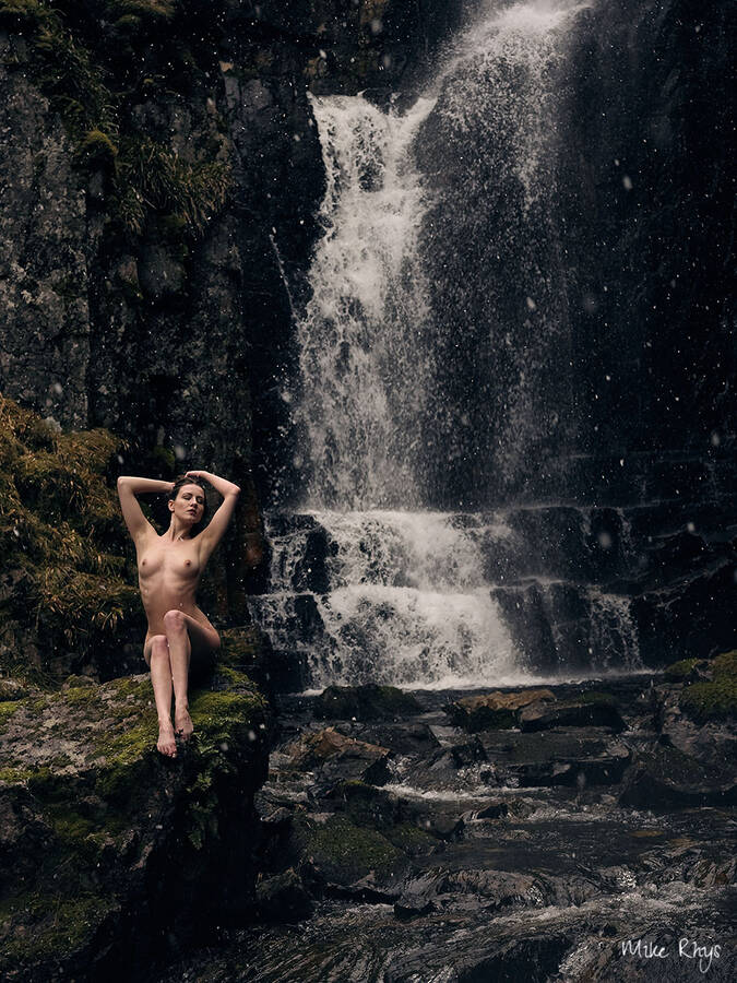 photographer MikeRhys classic modelling photo. artnude in the landscape scottish highlands easter 2018  a beautiful model in a scenic landscape with scotlands highest waterfall in the background and some snow drizzling it was freezing cold just slightly above 