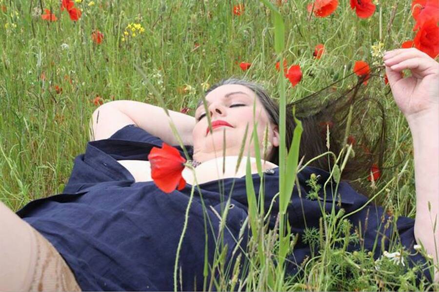model Cats Paw stilllife modelling photo. relaxing in a poppy field.