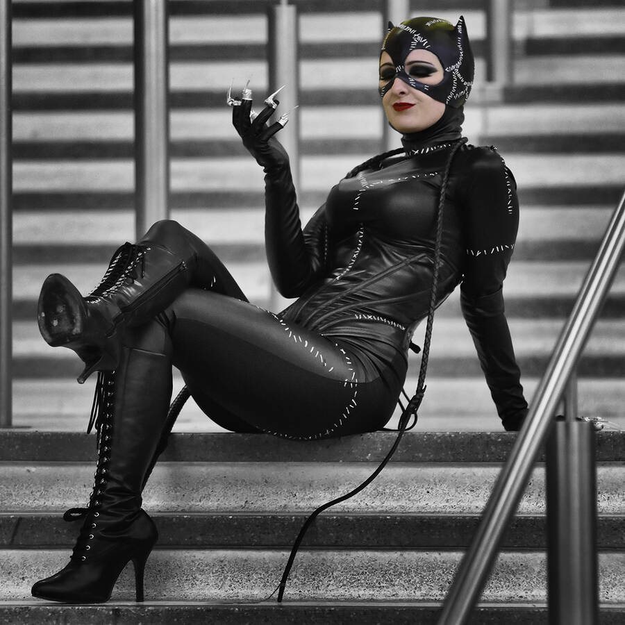 photographer DSGPhotos cosplay modelling photo. a photo of a catwoman cosplayer attending a comicon at the birmingham nec she was posing for a large group of photorgaphers that quickly gathered round when she started posing on the stairs.