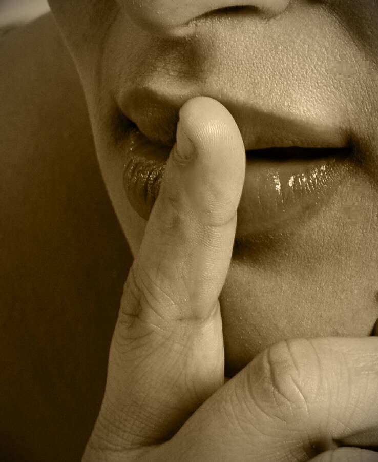 photographer Alan Tog body modelling photo. a close up of the models mouth with her finger indicating to be quiet shush.
